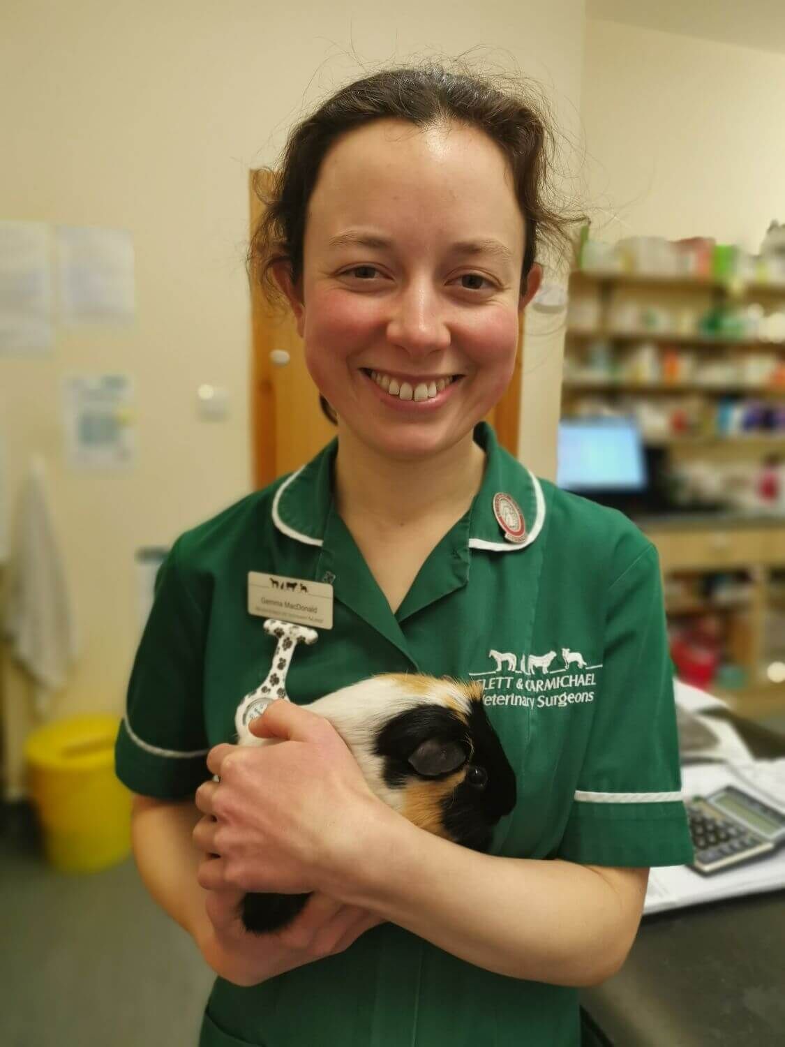 A nurse holding a small pet patient