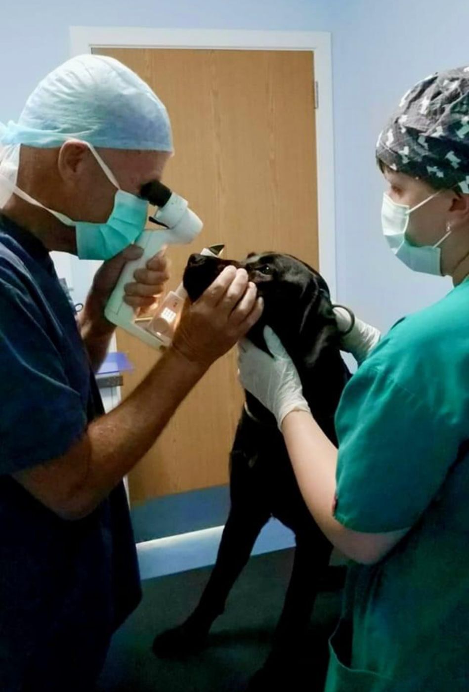 A visiting specialist carrying out an eye examination